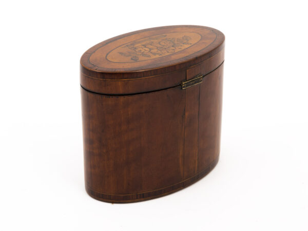 antique oval tea caddy side view on a white background