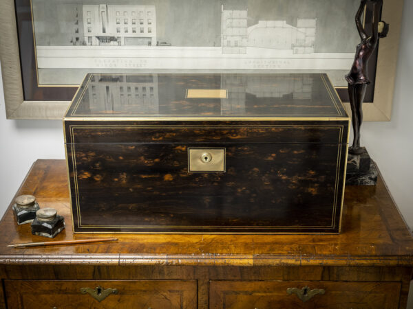 Coromandel writing box writing on display on a set of drawers