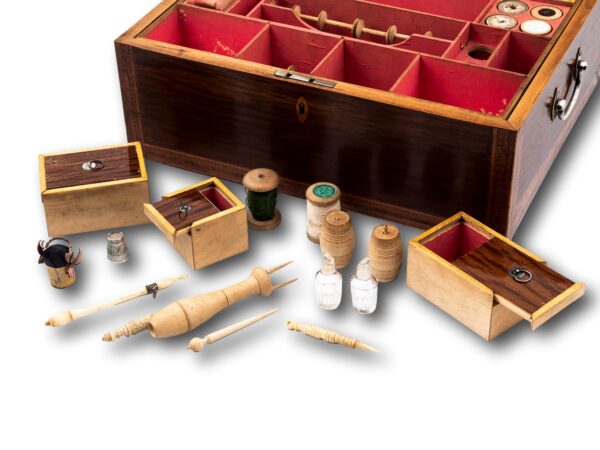 Close up of the various sewing instruments in the box removed from the tray