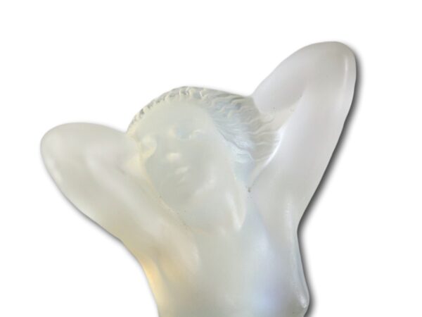 Close up of the face of the Rene Lalique car mascot