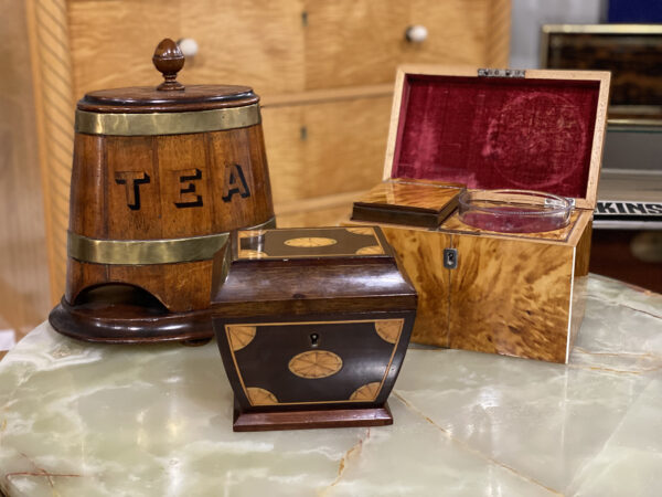 Edwardian Sarcophagus Tea Caddy in a decorative collectors setting with other tea caddies.
