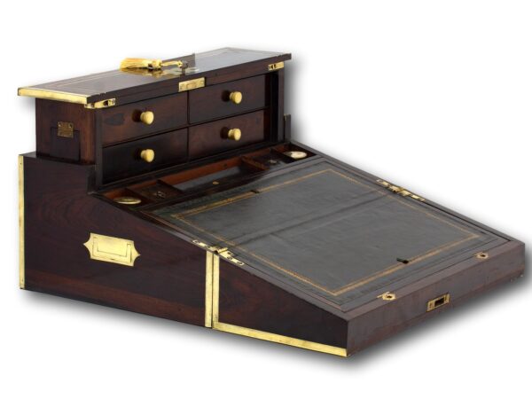 Overview of the Rosewood writing box opened showing the green leather writing slope and the rear drawers up