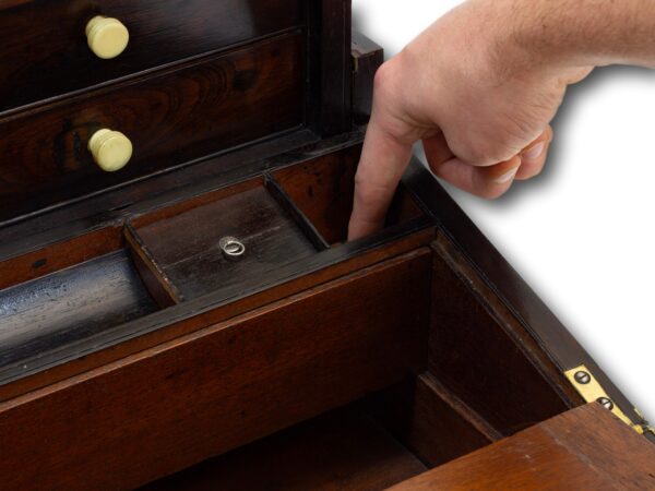 pressing down the hidden compartment latch