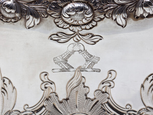 Close up of the family crest mark two arms meeting in the middle