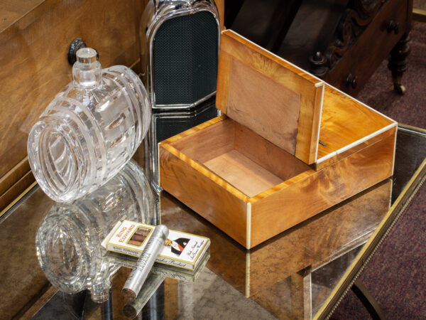 Overview of the George Betjemann Satinwood & Silver Humidor in a decorative setting