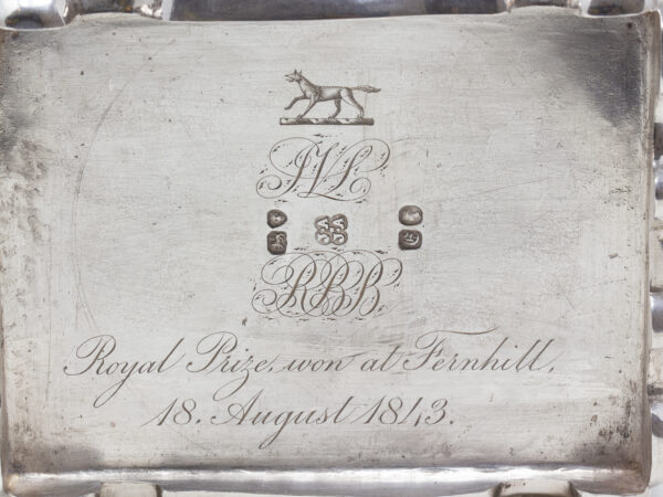 Close up of the crest, hallmarks and engraved writing to the base