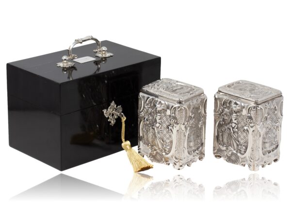 Overview of the Victorian Ebonised Royal Prize Tea Chest in a decorative picture with the caddies removed and key inserted
