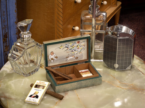 Overview of the cigarette case in a decorative collector setting