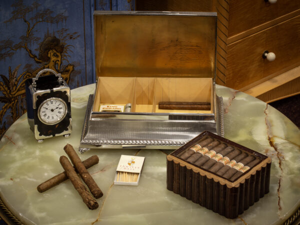 Overview of the sterling silver cigar box in a decorative collectors setting