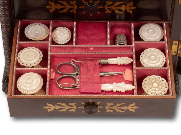 Close up of the second drawer filled with mother of pearl sewing kit