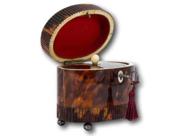 Front overview of the Regency Oval Tortoiseshell Tea Caddy with the lid up and the key fitted