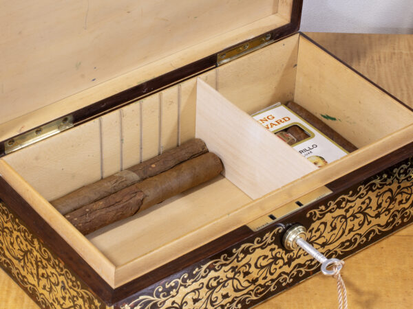 Overview of the English Boulle Cigar Box in a decorative setting with cigars fitted inside