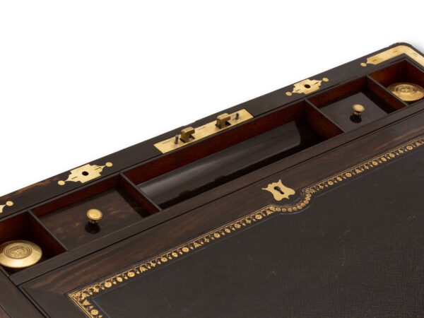 Close up of the top half of the writing box showing the inkwell, pen tray and lidded compartments