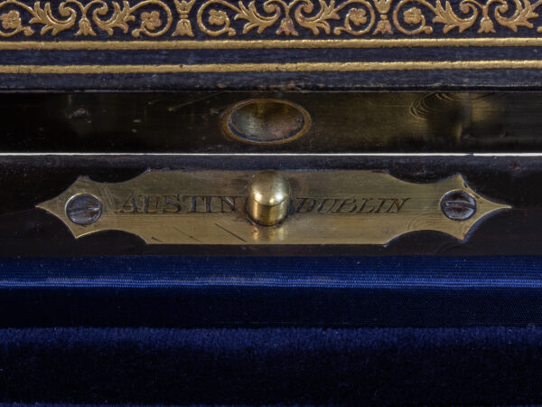 Close up of the Thomas and George Austin of Dublin makers mark around the push button