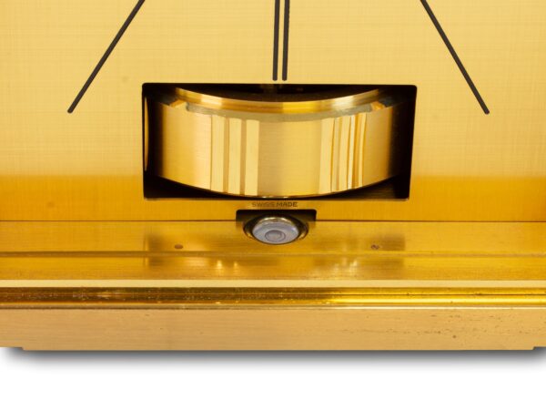 Close up of the pendulum and swiss made on the dial