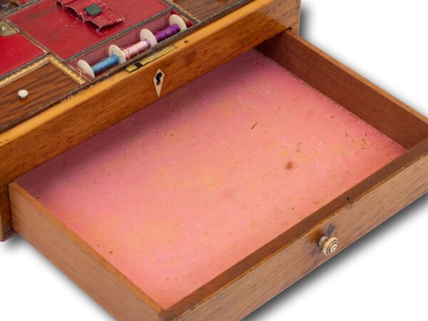 Close up of the pull out storage drawer in the Antique Rosewood Sewing Box