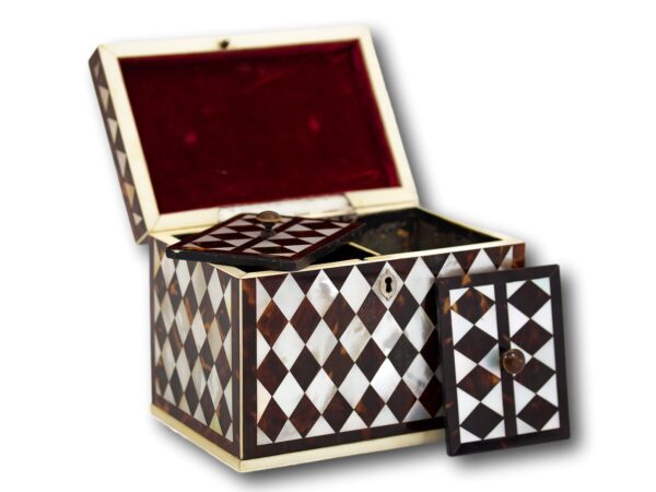 Front overview of the Tortoiseshell and Mother of Pearl Harlequin Tea Caddy with the lid up and caddy lids placed decoratively