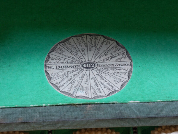 Close up of the William Dobson makers mark in the Amboyna Sewing Box