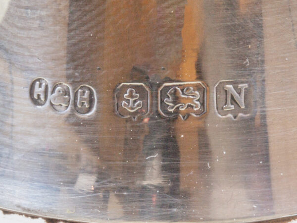 Close up of the sterling silver hallmarks on the collar of the decanter from the Stamford Bridge Tantalus Hukin & Heath