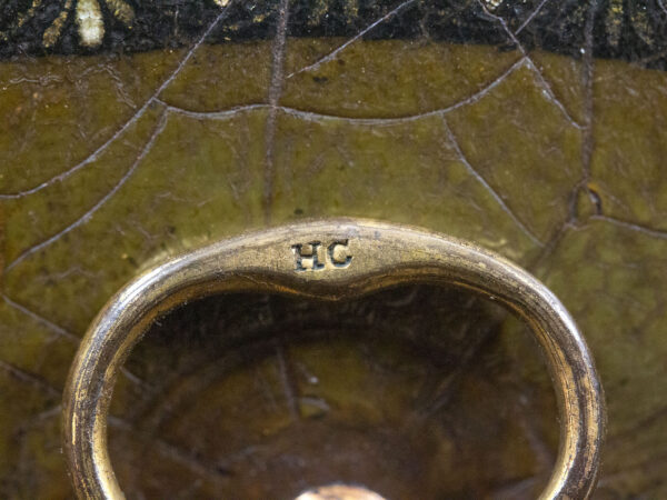 Close up of the HC stamped handle on the Papier Mache Tea Caddy Henry Clay