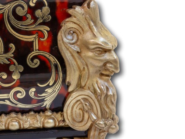 Close up of the ormolu mask mounts on the French Boulle Tea Caddy