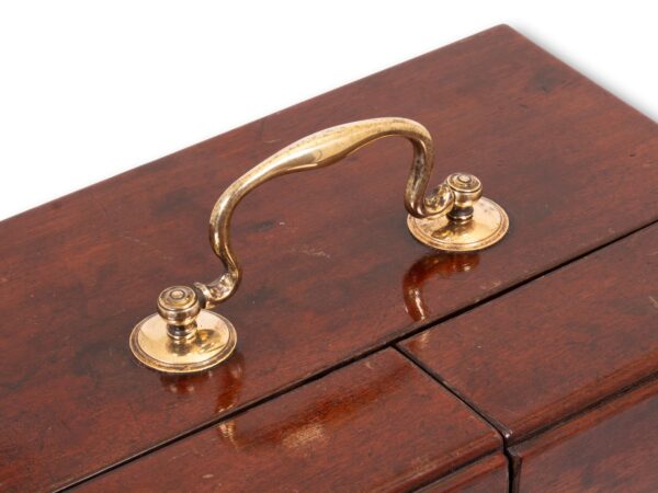 Close up of the top handle from the Mahogany Apothecary Cabinet with Poison Compartment