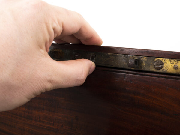 Close up of the secret compartment access in the inner lid of the Campaign Military Writing Box Hewlins