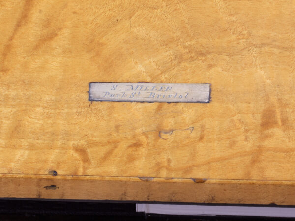 Close up of the retailers label inside the Coromandel Silver Mounted Writing Box Betjemann