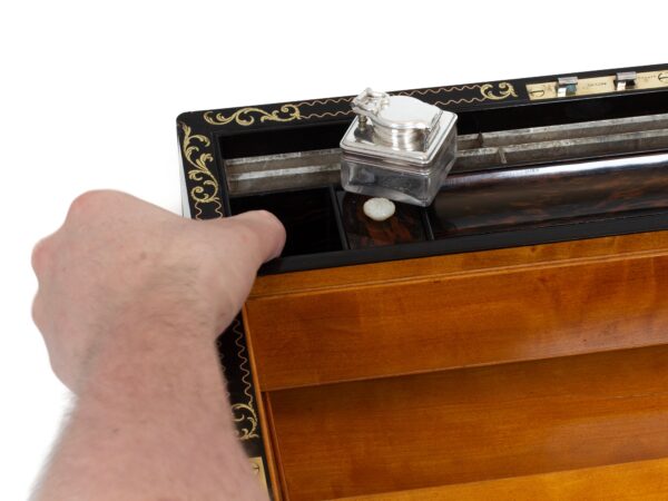 Close up of the secret compartment activation in the Coromandel Inlaid Writing Box Hausburg