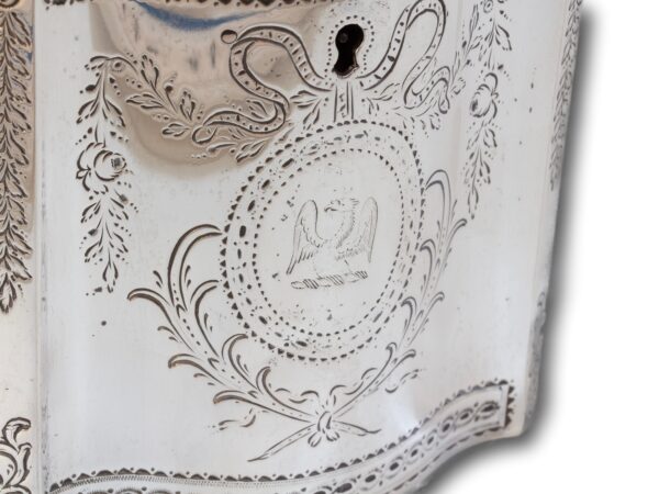 Close up of the eagle family crest on the front of the Georgian Silver Tea Caddy by William Vincent