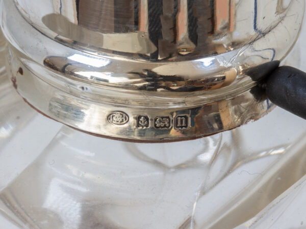 Close up of the sterling silver hallmarks from the Pair of Tilting Decanters Hukin & Heath