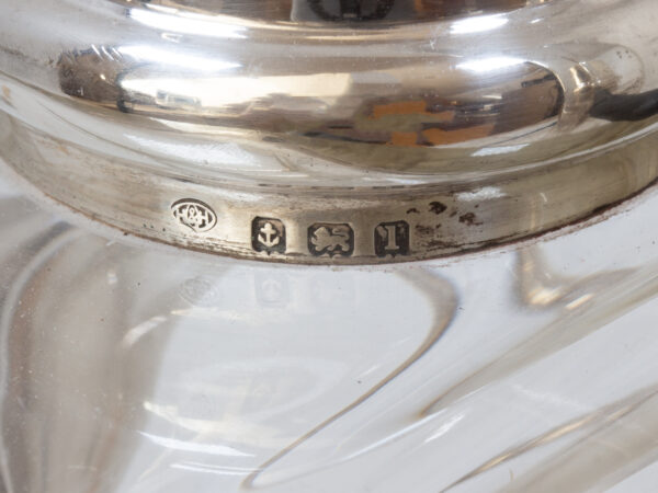 Close up of the sterling silver hallmarks from the Pair of Tilting Decanters Hukin & Heath